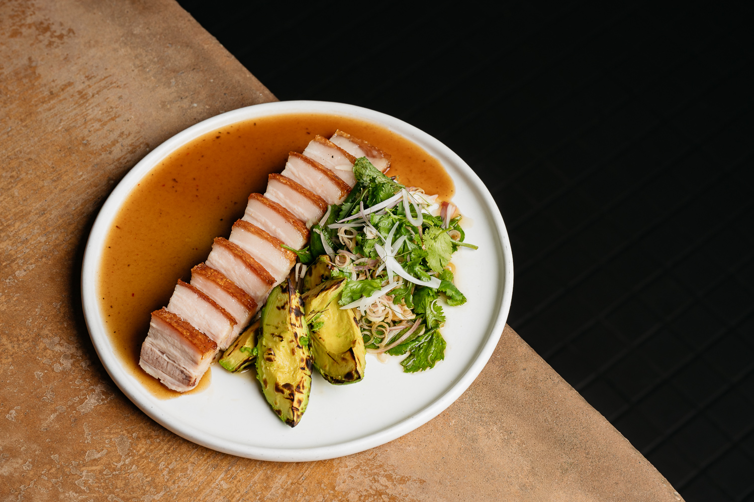 Grilled Australian Avocado, Crispy Pork Belly, Nahm Dtok, Mint, Tamarind, Roasted rice dressing